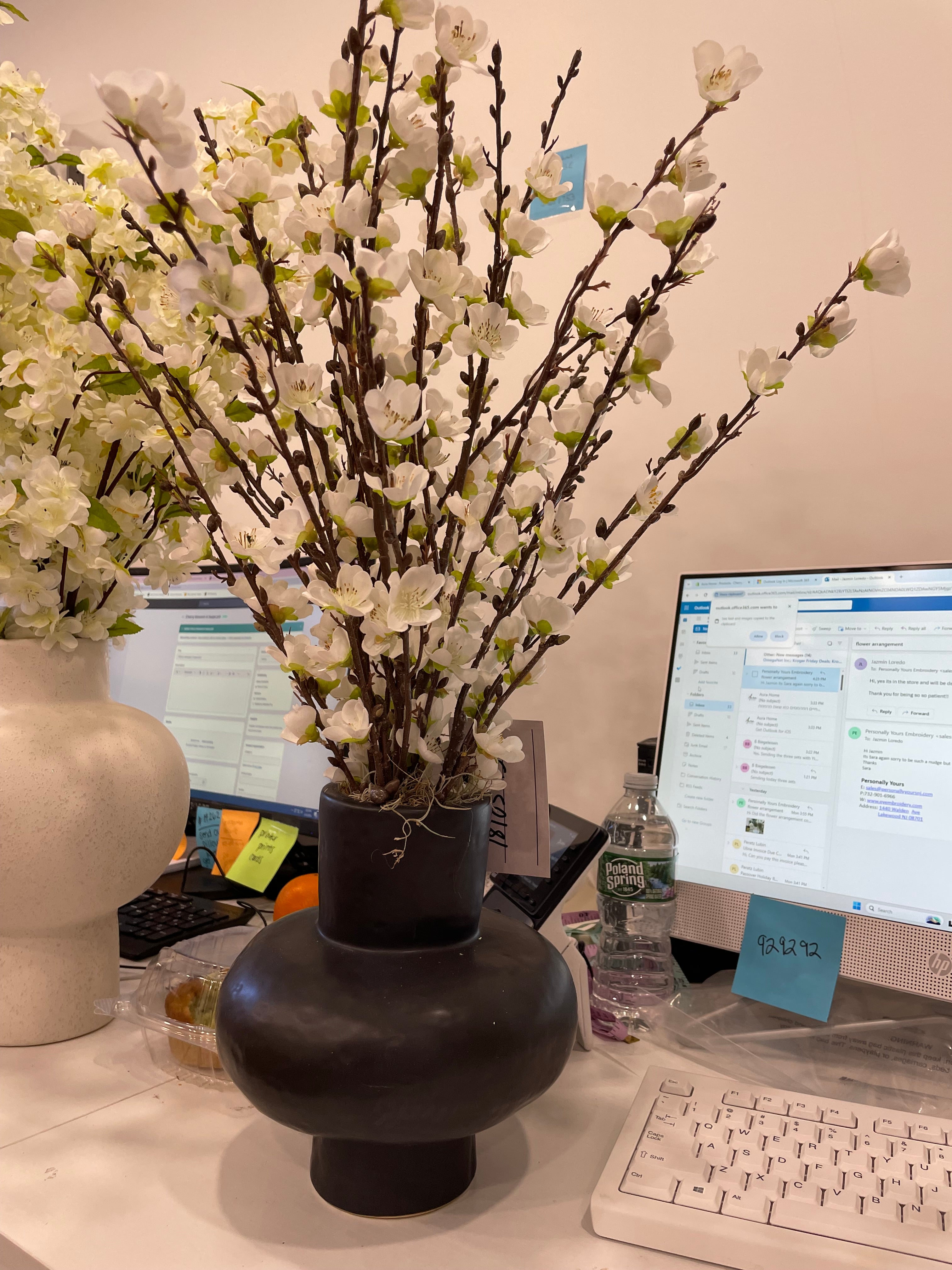 Faux cherry blossom branch in black pot