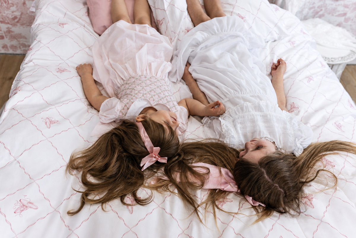 Two children together on a Petite Belle bed